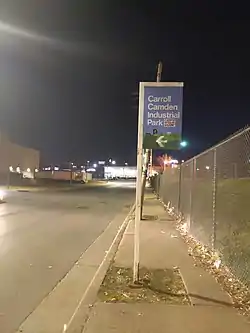 Guidepost sign pointing an entry to the Carroll-Camden Industrial Area from Russell Street in Baltimore