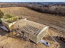Post frame garage connected to traditional frame house