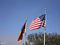 The Armenian and American flags in front of the church