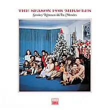 The group and their families seated around a Christmas tree