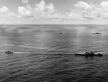 USS Canberra (foreground) and Houston (background) under tow on 18 October